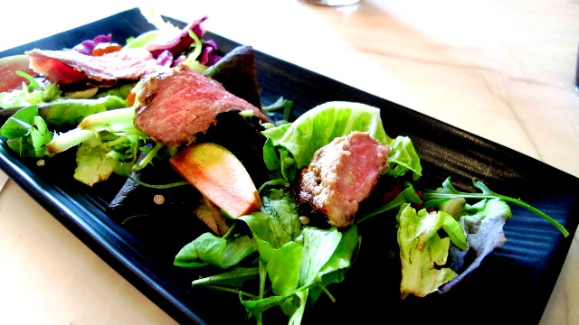 Grilled Australian Striploin with Bukidon Organic Greens Quinoa and Pickled Watermelon Radish with Honey Lime Vinaigrette.