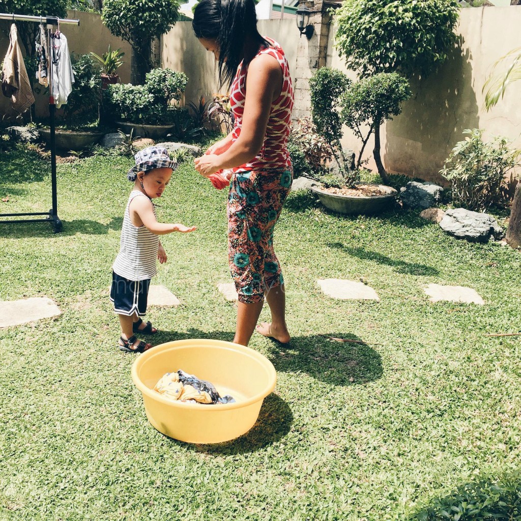 noah playing with laundry